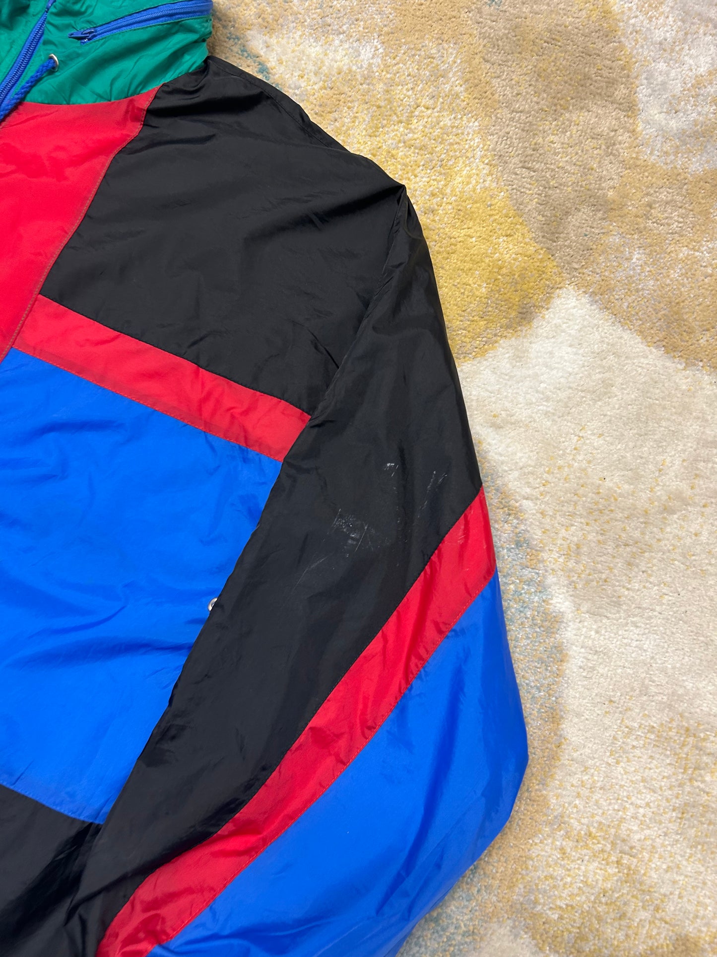 Black blue red and green windbreaker